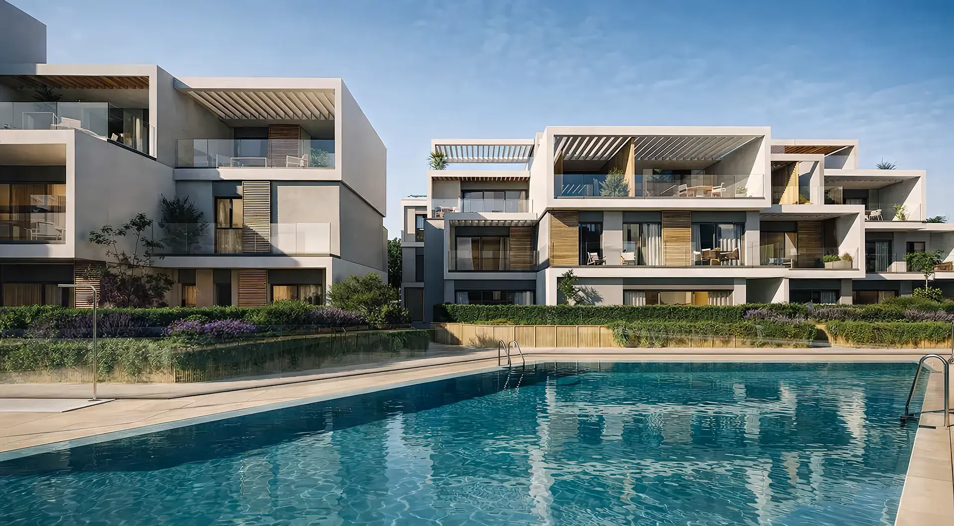 Modern apartment buildings at Isla Bela with a large outdoor swimming pool in Nueva Andalucía, Marbella