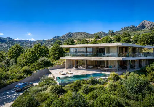Luxury villa Colmenar de Montemayor contemporary hillside villa with glass walls, infinity pool and mountain surroundings