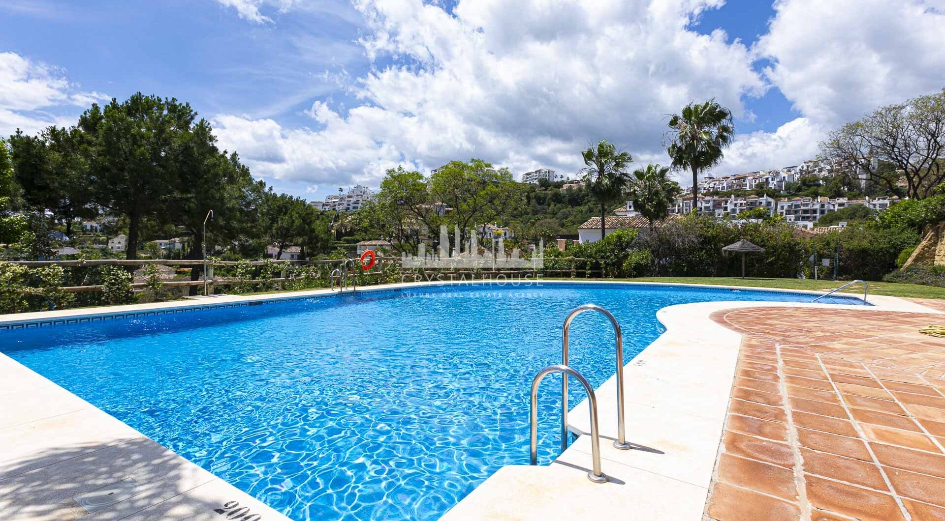 Beautiful south-facing, four bedroom townhouse in Los Almendros, part of the secure Los Arqueros Golf community in Benahavís