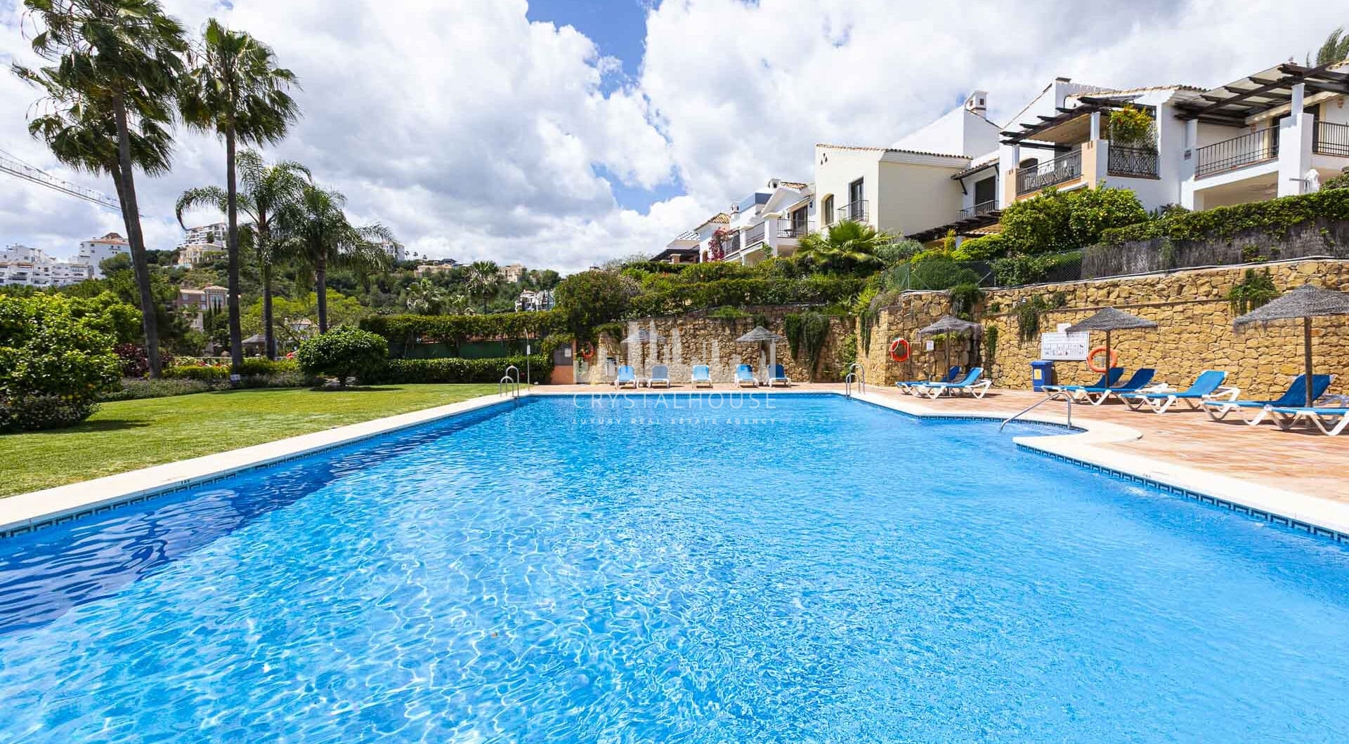 Beautiful south-facing, four bedroom townhouse in Los Almendros, part of the secure Los Arqueros Golf community in Benahavís