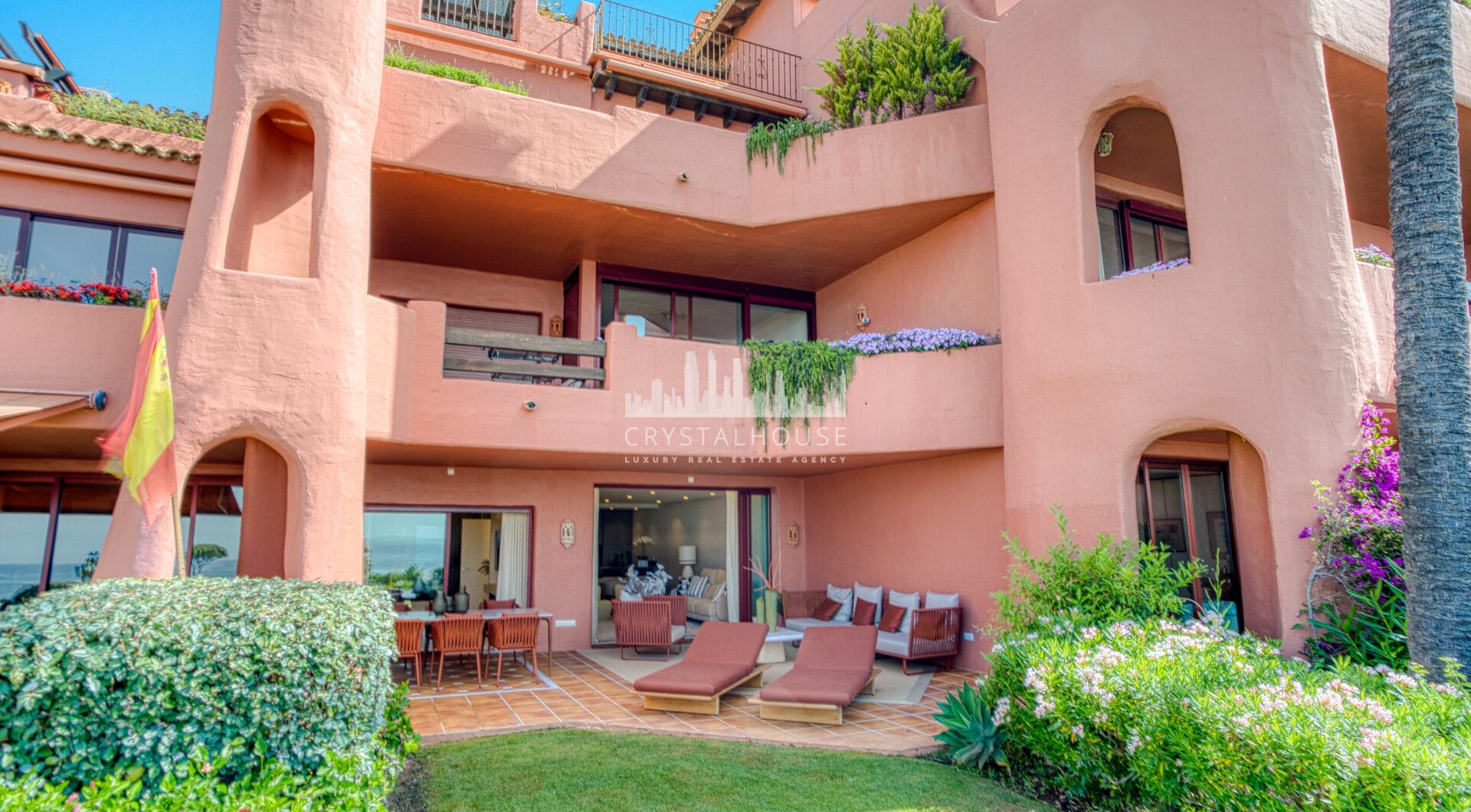 Impeccably renovated, south facing beach front, garden apartment located in the exclusive Menara Beach community on the sought-after New Golden Mile