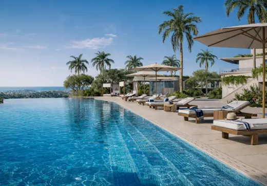 Azurean Marbella infinity pool with sun loungers, palm trees, sea views and exclusive luxury residential lifestyle