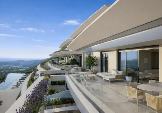 Azurean Marbella luxury apartment terrace with outdoor seating, glass balustrades, panoramic views and modern architecture